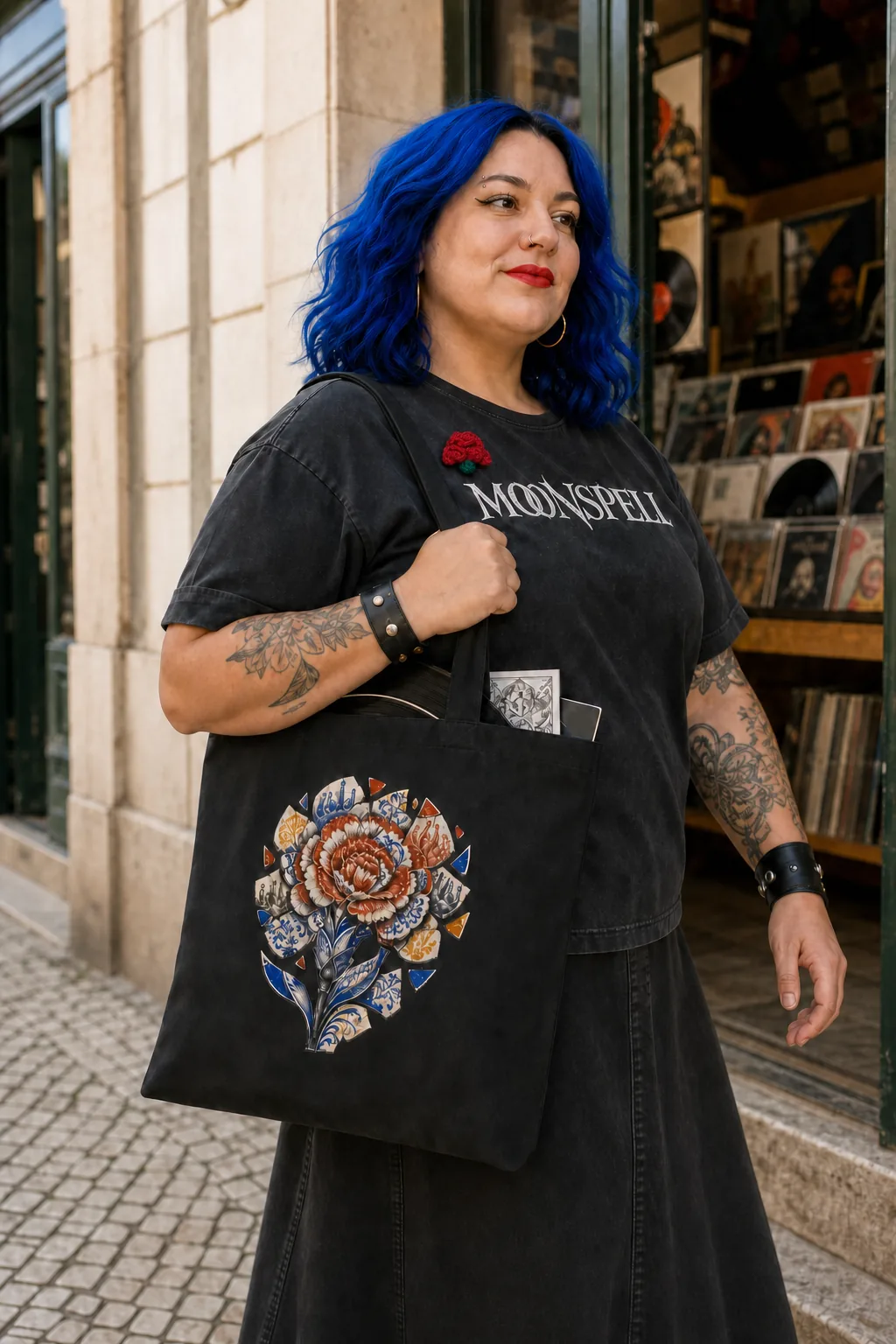 Pessoa com o Tote Azulejo Quebrado preto ao ombro e o cravo de lã ao peito